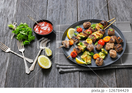 beef kebabs with zucchini and tomatoes on skewers 126784429