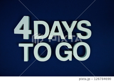 4 Days to go alphabet letters top view on navy blue background 126784690