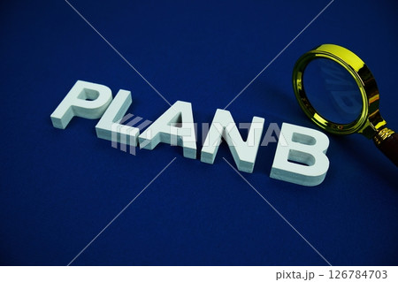 Plan B alphabet letters with magnifying glass top view Plan B alphabet letters with magnifying glass top view 126784703