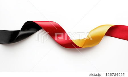 red, yellow and black ribbon or banner. The ribbon is made of a shiny, satin-like material and has a smooth texture.	 126784925