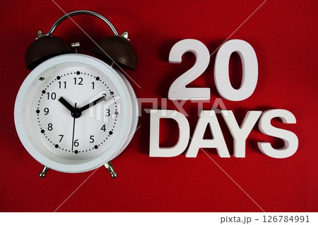 20 Days alphabet letters with alarm clock on red background 20 Days alphabet letters with alarm clock on red background 126784991