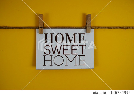 Home Sweet Home text on paper card on yellow background Home Sweet Home text on paper card on yellow background 126784995