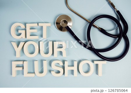 Get Your Flu Shot alphabet letters with stethoscope top view on blue background Get Your Flu Shot alphabet letters with stethoscope top view on blue background 126785064