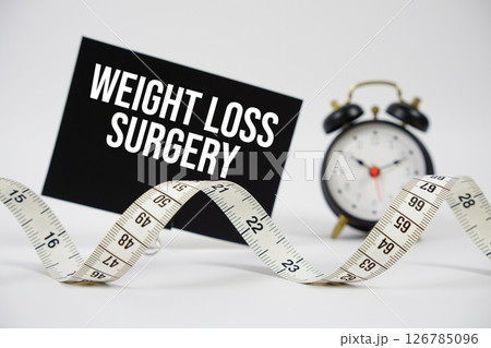 Weight Loss Surgery text with alarm clock and measuring tape on white background 126785096