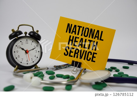 National Health Service text with alarm clock and Stethoscope on white background National Health Service text with alarm clock and Stethoscope on white background 126785112