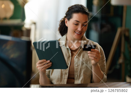 Woman is doing online purchases 126785802