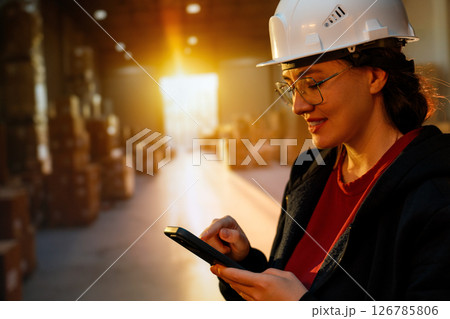 Young woman is working in warehouse 126785806