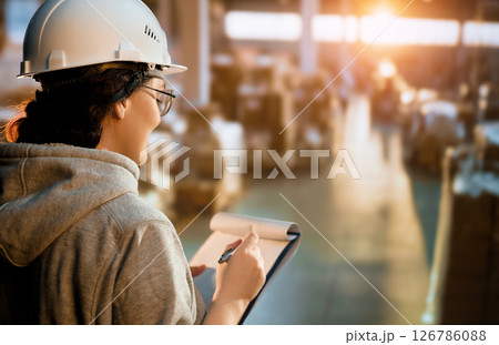 Young woman is working in warehouse Young woman is working in warehouse 126786088