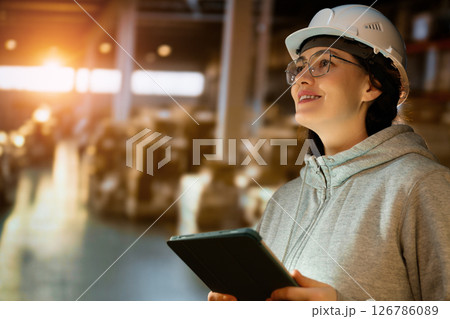Young woman is working in warehouse Young woman is working in warehouse 126786089