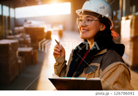 Young woman is working in warehouse Young woman is working in warehouse 126786091