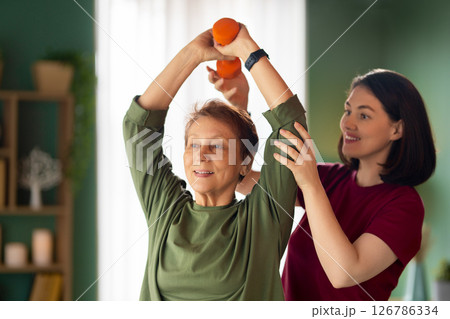 Senior woman doing dumbbell exercise 126786334