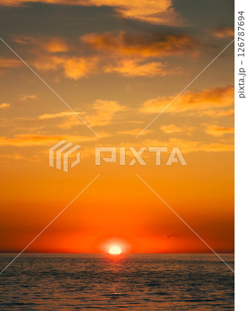 Sunlight Giving Orange Color To The Sunset Sky Sunlight Giving Orange Color To The Sunset Sky 126787694