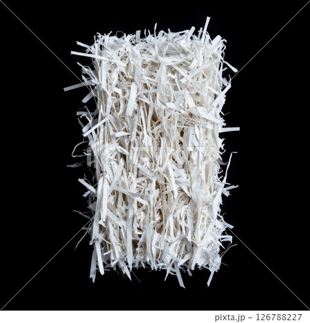 Detailed View of Shredded Paper Arranged Neatly on Black Background Detailed View of Shredded Paper Arranged Neatly on Black Background 126788227