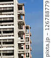 A high-rise apartment building against a blue sky. 126788779
