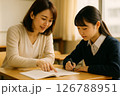 個別指導でノートを指差す女性講師と中学生（安心） 126788951