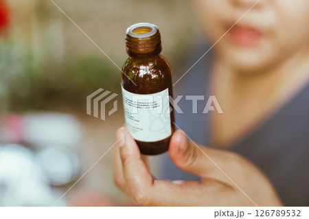 Shot of mature perfumer adding extra essential oil 126789532