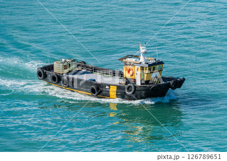 Industrial Tugboat Sailing on Blue Water 126789651