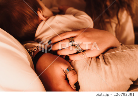 Loving Embrace of Mother and Child in Warm Setting Loving Embrace of Mother and Child in Warm Setting 126792391