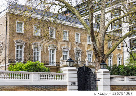Classic British Brick Home with Iron Gate and White Trim in Upscale Neighborhood 126794367