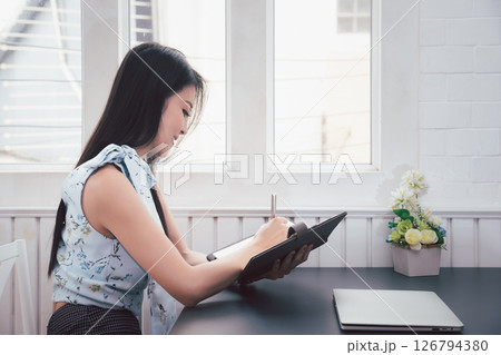 Young asian woman in smart casual wear working in home office. Social distance practice prevent coronavirus COVID-19. 126794380