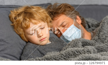 Sick Father and Child Sleeping Together in Bed 126794971