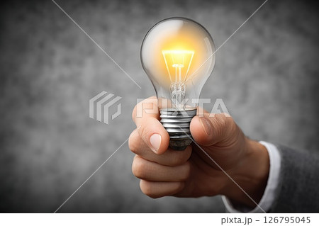 Hand Holding Illuminated Light Bulb Concept of Innovation 126795045