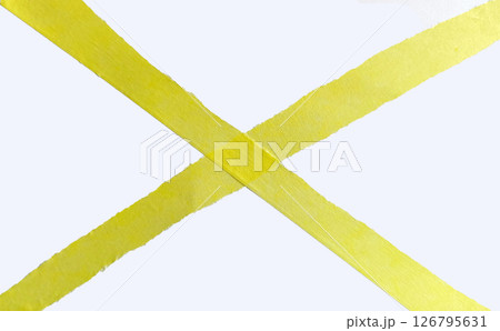 Yellow torn paper with ragged edges laid out in a cross, paper tape strips isolated on white background.  126795631