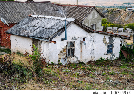Old abandoned house falling apart in Crimea, Russia Old abandoned house falling apart in Crimea, Russia 126795958