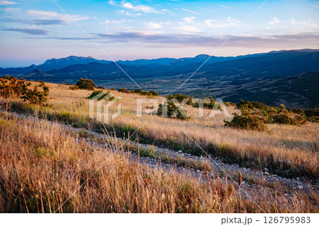 Golden hour illuminating Crimean mountains and valley landscape 126795983