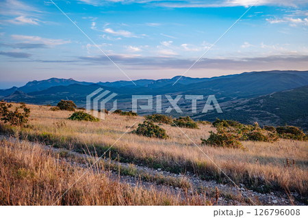 Scenic Crimean Landscape with Rolling Hills and Mountains at Sunset 126796008