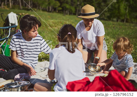 Family Enjoying a Scenic Picnic in the Mountains 126796152