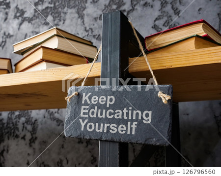 Bookshelf with the phrase keep educating yourself symbolizing lifelong learning. 126796560