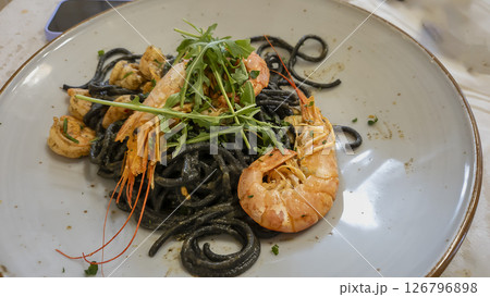 Plate of black spaghetti with prawn, mussels. Healthy food concept. 126796898