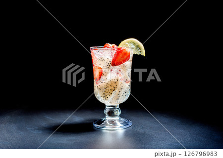 Dragon fruit and strawberry cocktail with ice and a slice of lemon. Dragon fruit and strawberry cocktail with ice and a slice of lemon. 126796983
