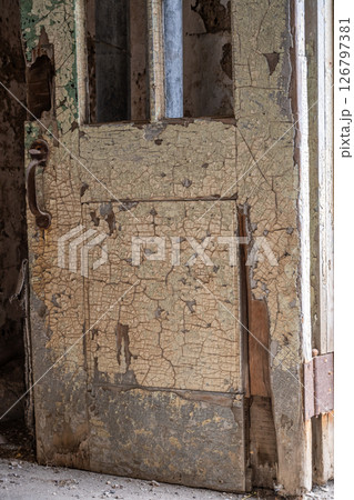 Chipped and peeling lead based paint on an old wall. Chipped and peeling lead based paint on an old wall. 126797381