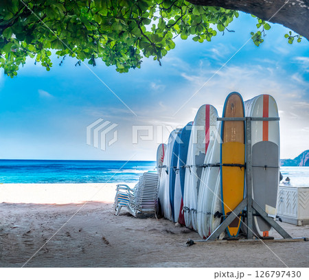 Row of locked and stacked surfboards at a beach resort in Waikiki, Hawaii in the morning. Row of locked and stacked surfboards at a beach resort in Waikiki, Hawaii in the morning. 126797430