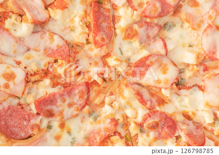 Pizza with salami and cheese as a background macro photo. Pizza with salami and cheese as a background macro photo. 126798785