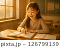 朝日差し込む教室で読書に夢中な小学生（希望） 126799139