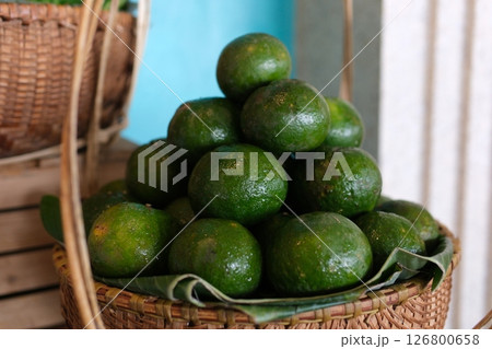 wicker baskets Fresh Vietnam green orange fruits on display at a local market in Vietnam wicker baskets Fresh Vietnam green orange fruits on display at a local market in Vietnam 126800658