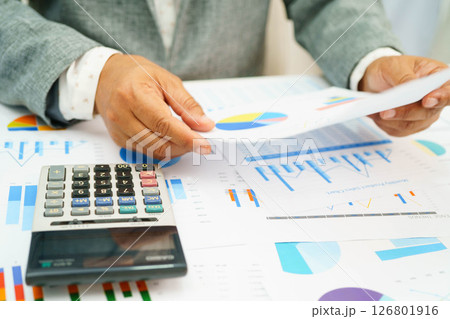 Asian business woman working with financial graph. Asian business woman working with financial graph. 126801916