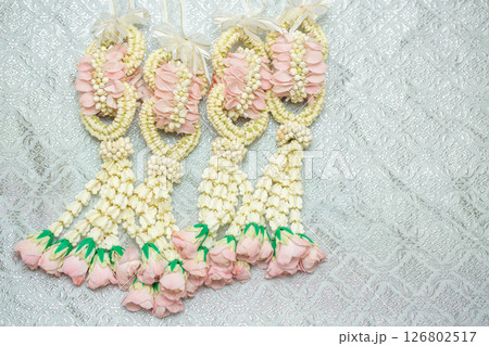 Beautiful Thai-style jasmine garland on a silver cloth background with an ancient Thai pattern. 126802517