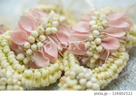 Beautiful Thai-style jasmine garland on a silver cloth background with an ancient Thai pattern. 126802522