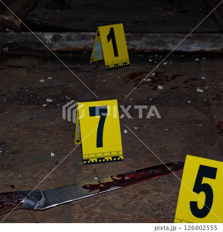 Bloody handprint and bloody knife at crime scene with yellow evidence marker. High quality photo Bloody handprint and bloody knife at crime scene with yellow evidence marker. High quality photo 126802555