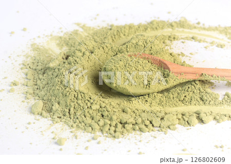 Japanese powdered matcha green tea on wooden spoon. Antioxidant, healthy, organic product. Beverages and nutrition. Isolated image on white background. Japanese powdered matcha green tea on wooden spoon. Antioxidant, healthy, organic product. Beverages and nutrition. Isolated image on white background. 126802609