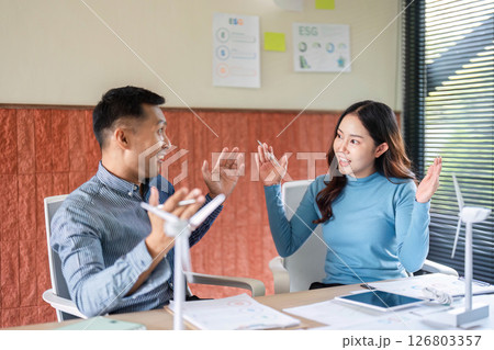 ESG Strategies in Business. Engaged professionals discussing sustainable practices in the office. ESG Strategies in Business. Engaged professionals discussing sustainable practices in the office. 126803357