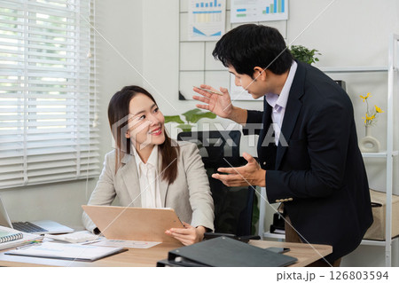 Engaging Financial Discussion. Business professionals sharing insights in a modern office. 126803594