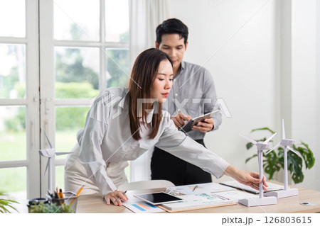 ESG and Business Engagement. Professionals analyzing renewable energy concepts in a bright office. 126803615