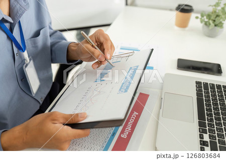 Accounting Professional Analyzing Financial Data with Laptop and Charts Accounting Professional Analyzing Financial Data with Laptop and Charts 126803684