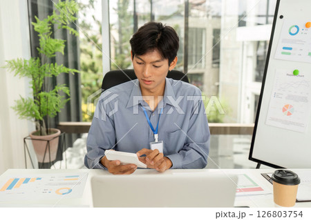 Data Management and Communication. Young professional using smartphone in office. 126803754
