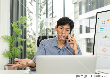 Young Professional Expressing Ideas During Phone Call in Modern Office 126803779